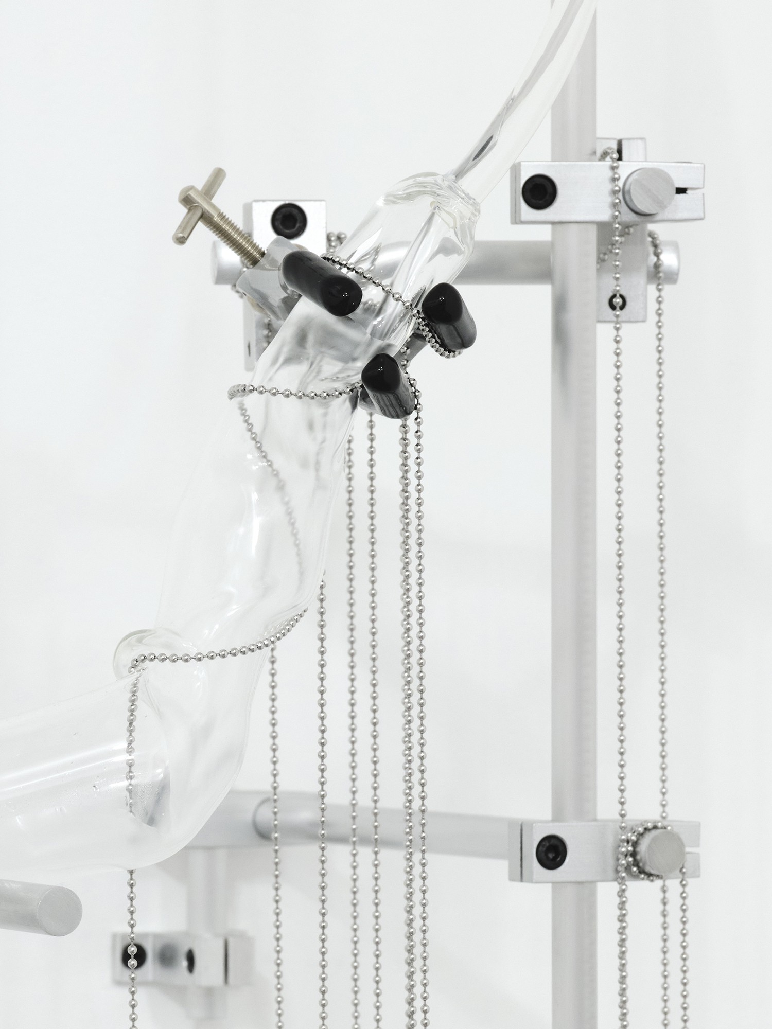 Soft Water, 2025,  [2m x 70cm x 40cm],  Spillâge [Curated by Haze Projects] Standpoint Gallery, London  Glass, water, plastic tank, aluminium, labels, pump, metal components and drain chain 