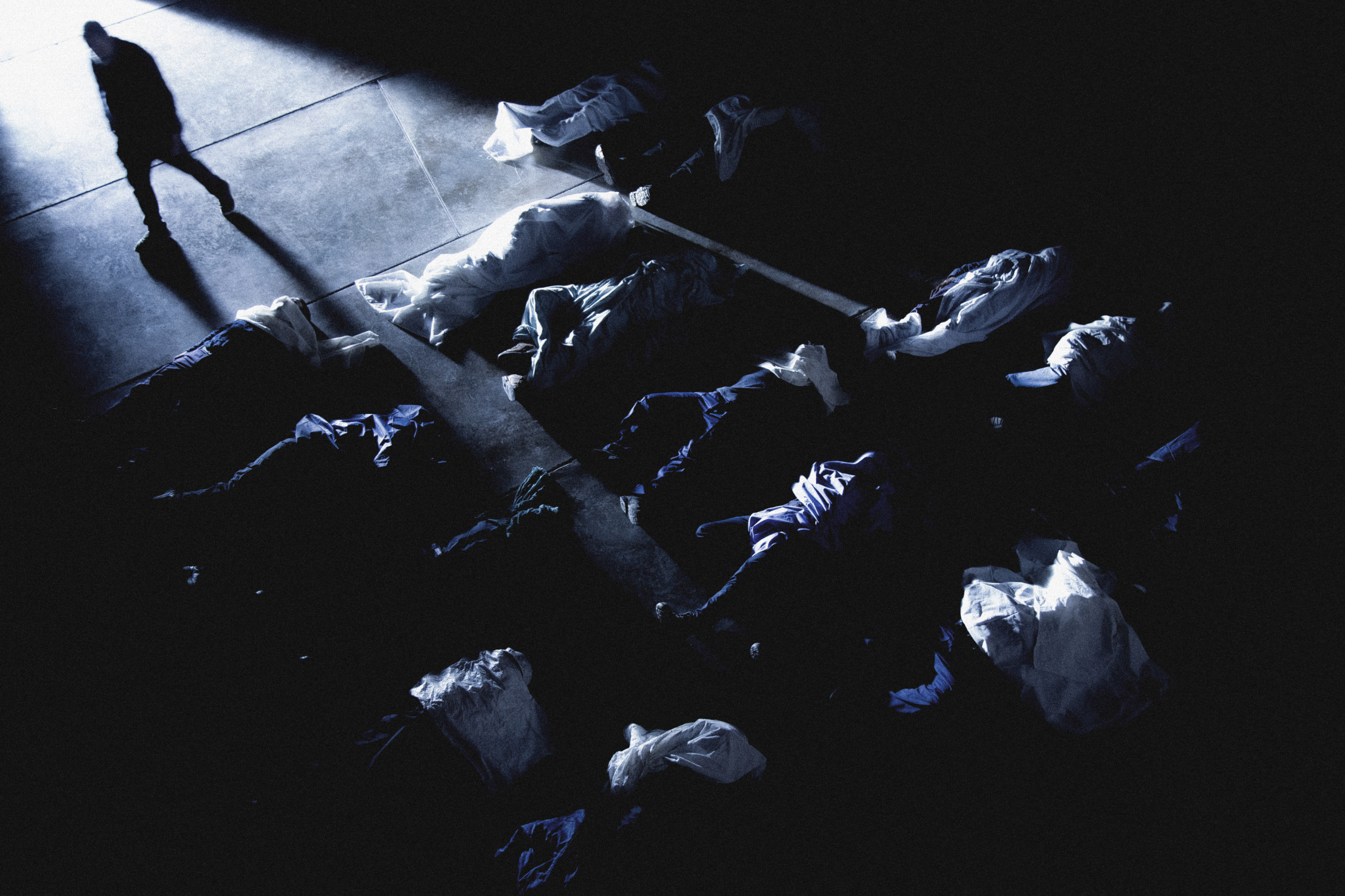 Man working alongside corpses