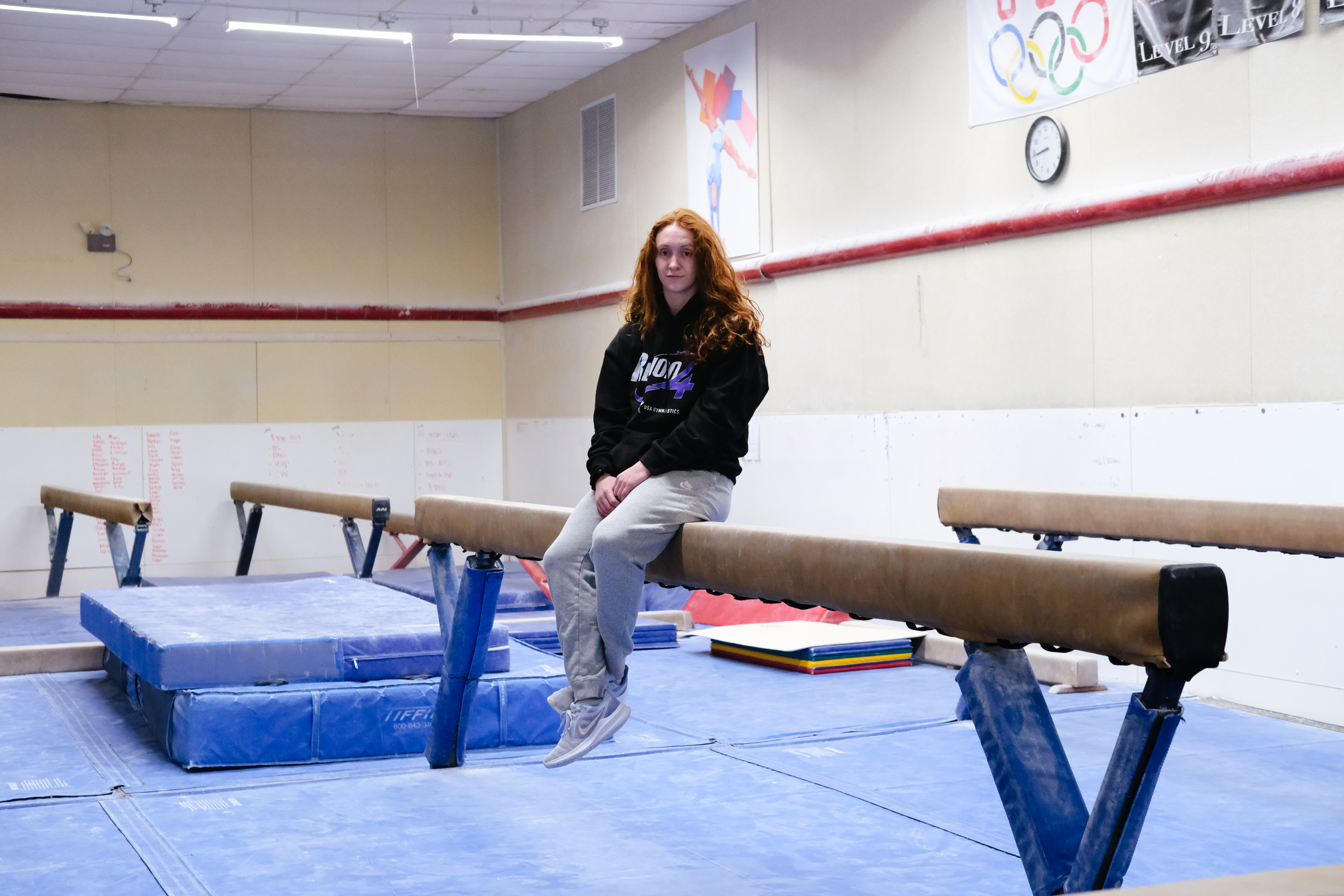 Libby, 21, poses in her gymnastics gym in Omaha, NE. She took the year off from college to coach children and transfer schools.  