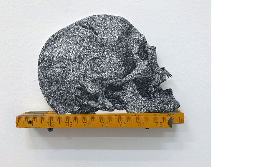 Douglas Rodrigo Rada, Skull + Meter, 2017. Ink on paper and wood meter 7 x 10 Inches.