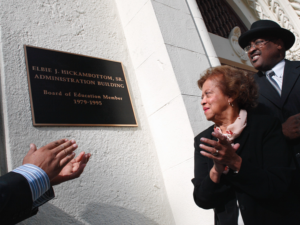 Dolores Hickambottom and Rev. William J. Johnson applaud during the dedication of John Muir High School's administration building in Pasadena, California, on November 13, 2004. The building was named after Hickambottom's husband, Elbie, a former school board president, who died earlier in the year. Ho-Yen Tsang for The Pasadena Star-News