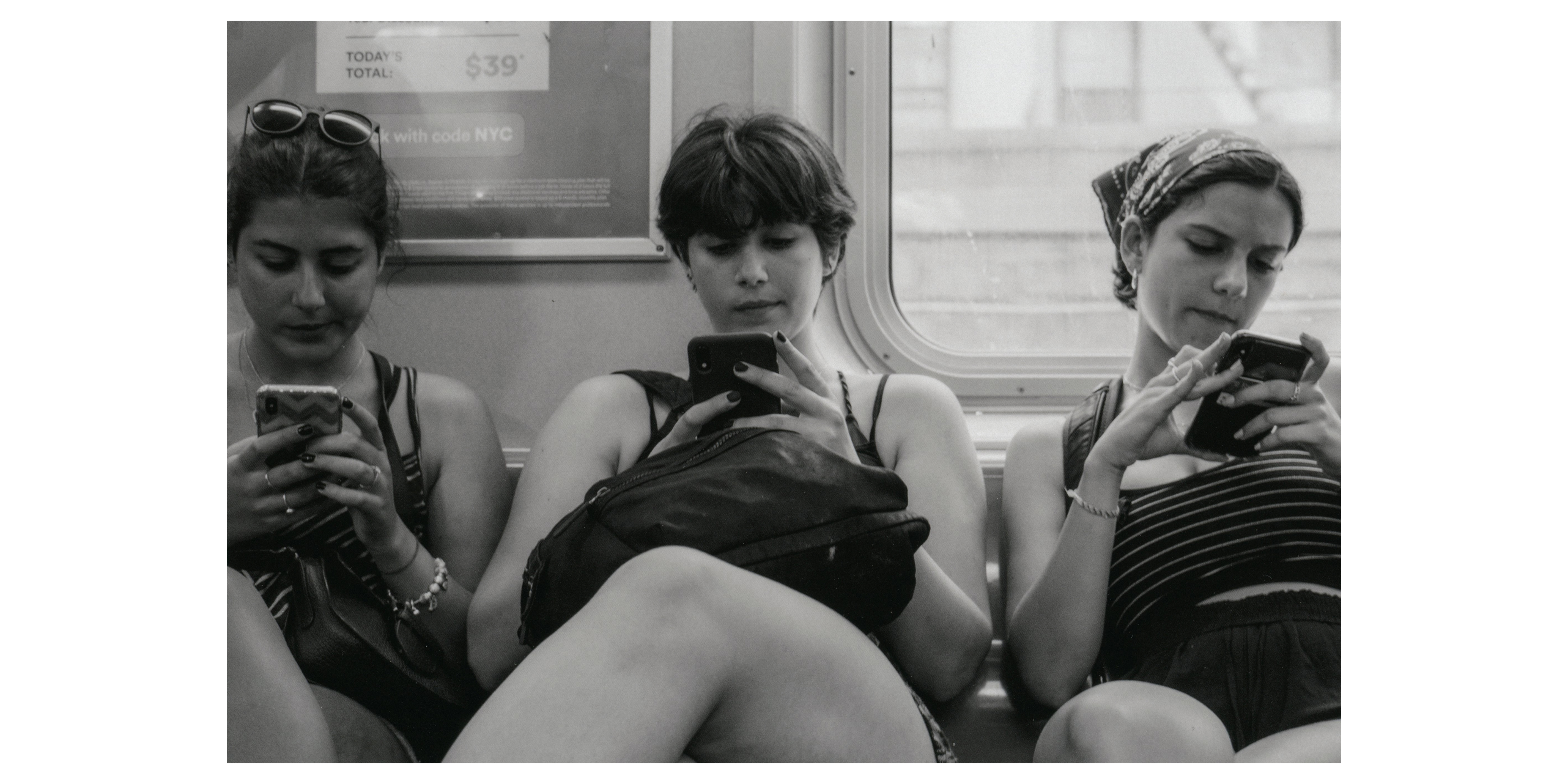 Girls on the train (on their phones), New York, 2019