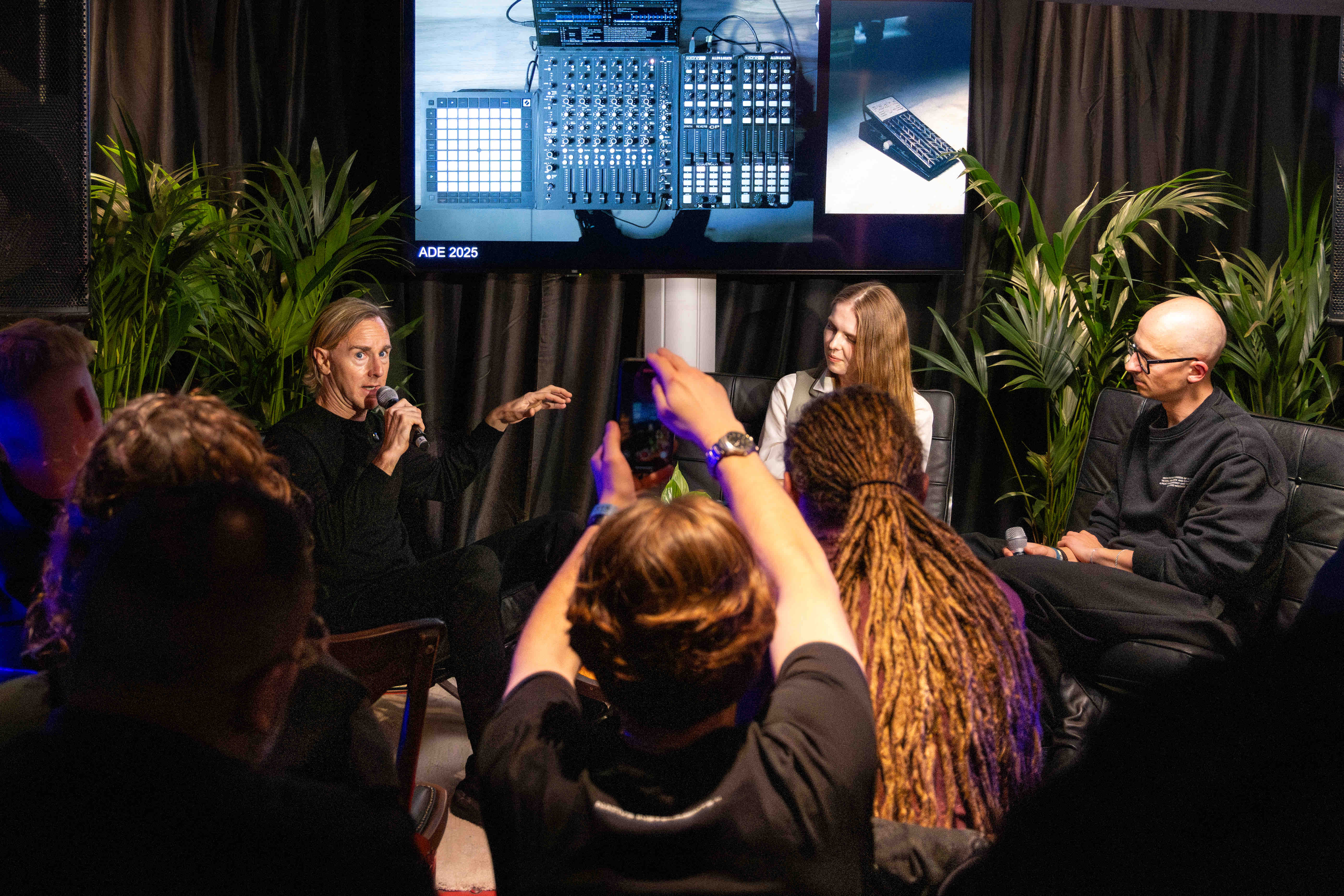 Richie Hawtin speaking on a Native Instruments panel at ADE 2025, produced by UP Productions