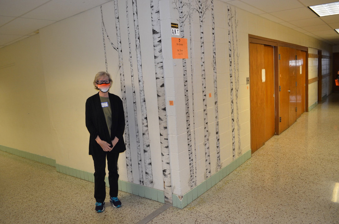 My mom standing in front of a beautiful birch mural she did.