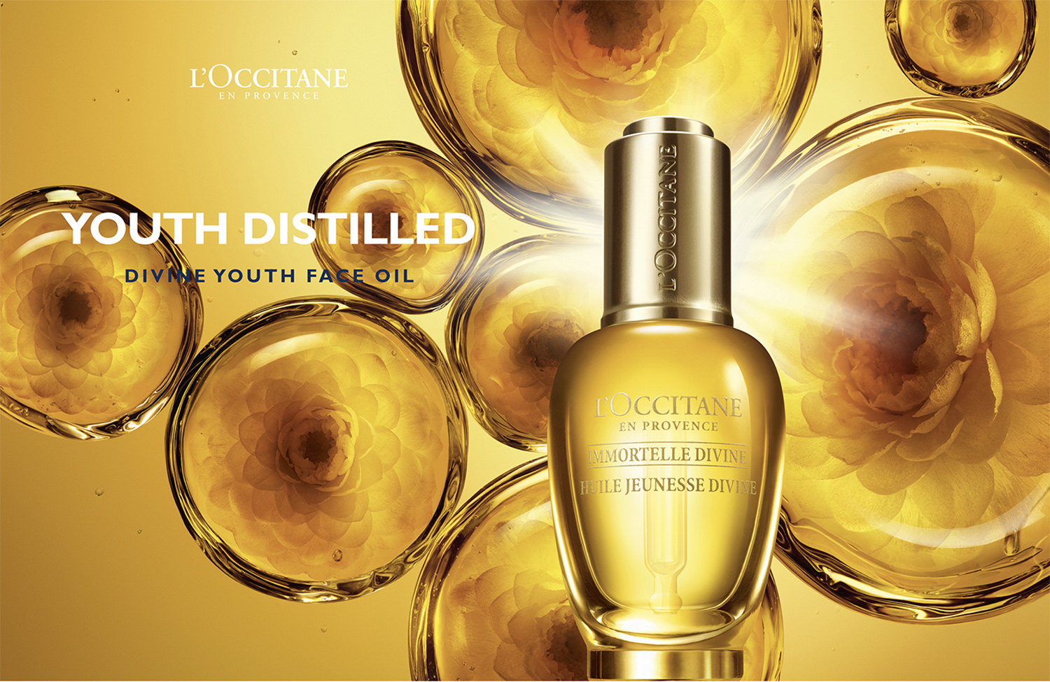 KMA photographer Daniel Schweizer photographs a yellow bottle of youth face oil for L'Occitane with yellow flower bubbles