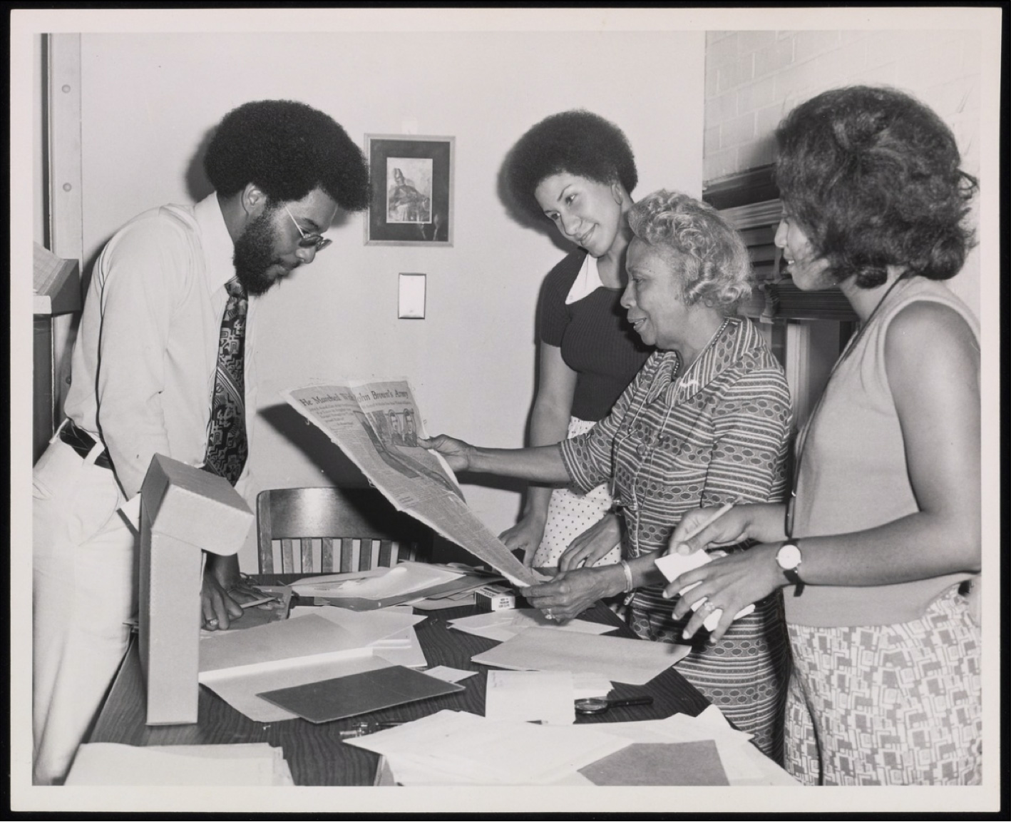 Image: Photograph of Dorothy Porter Wesley instructing Howard University manuscript staff: Thomas Battle, Evelyn Brooks-Barnett and Denise Glelin, July 1974. Beinecke Library, Box 101, Folder: 1974 D.P. M. F. Photographer: Unknown.