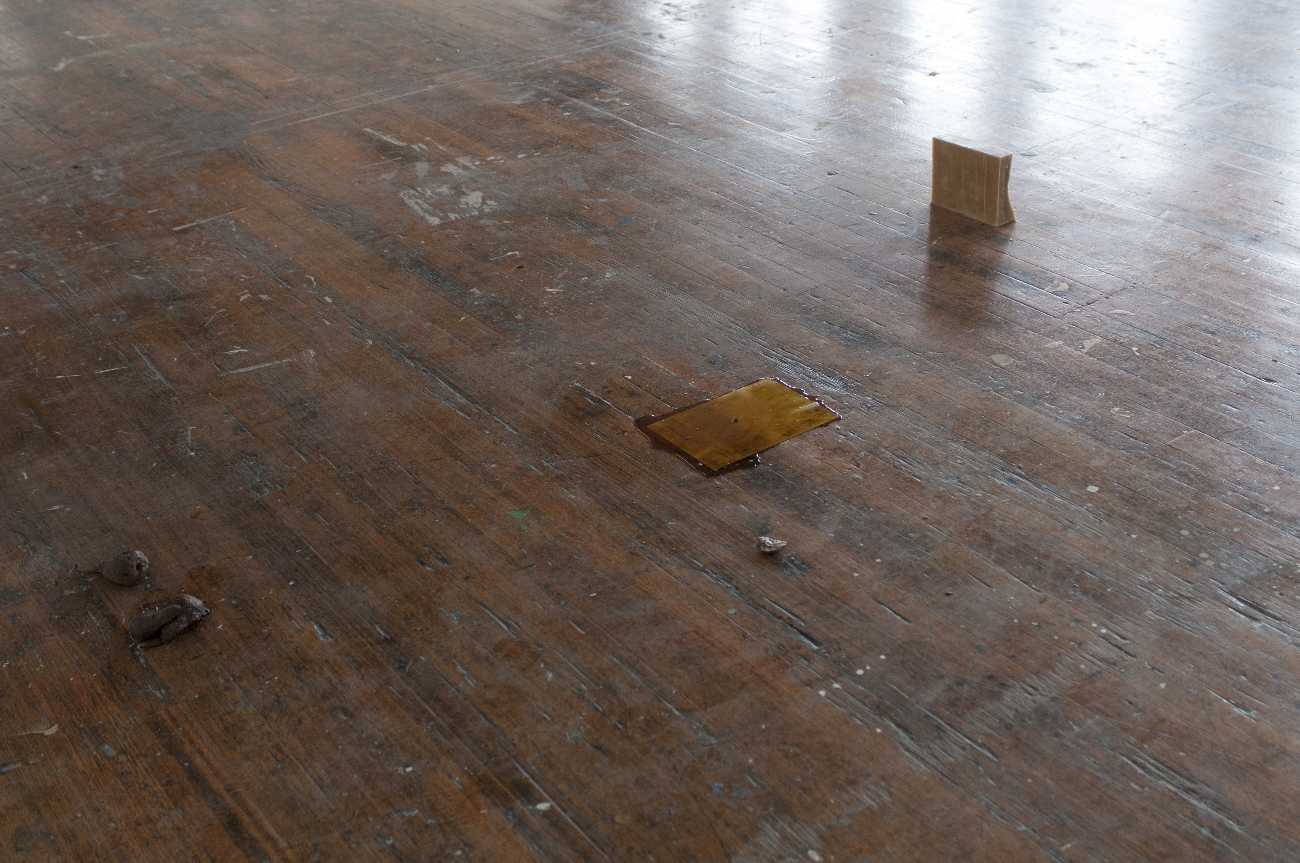 installation detail: rotting pears, email print-out (a) overlaid with pear syrup, bronze cast, wax block
