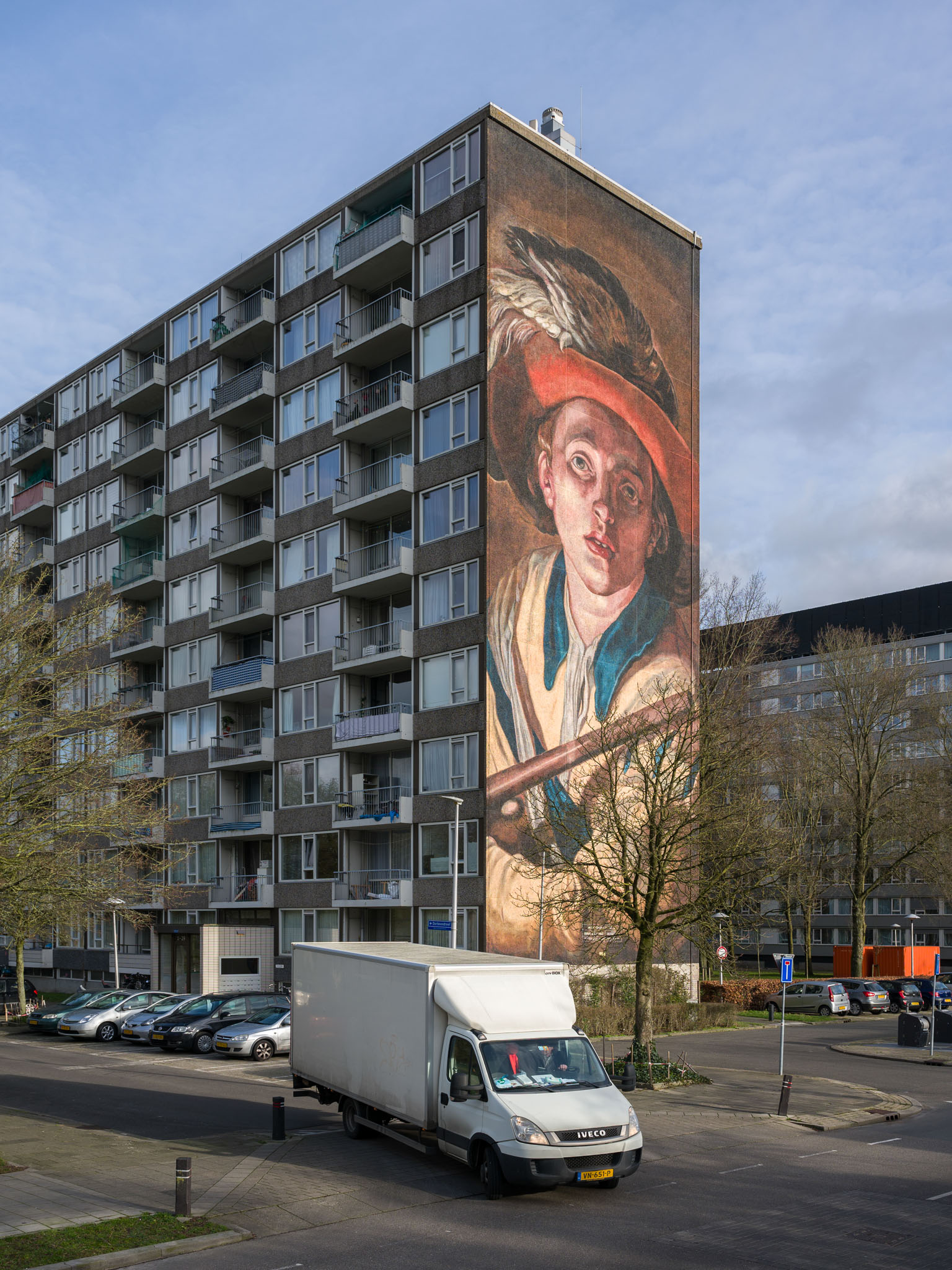 Wall painting by De Strakke Hand after the painting 'De Fluitspeler' (The Flute Player) by the Utrecht painter Abraham Bloemaert on the side of a tower block in Overvecht.
