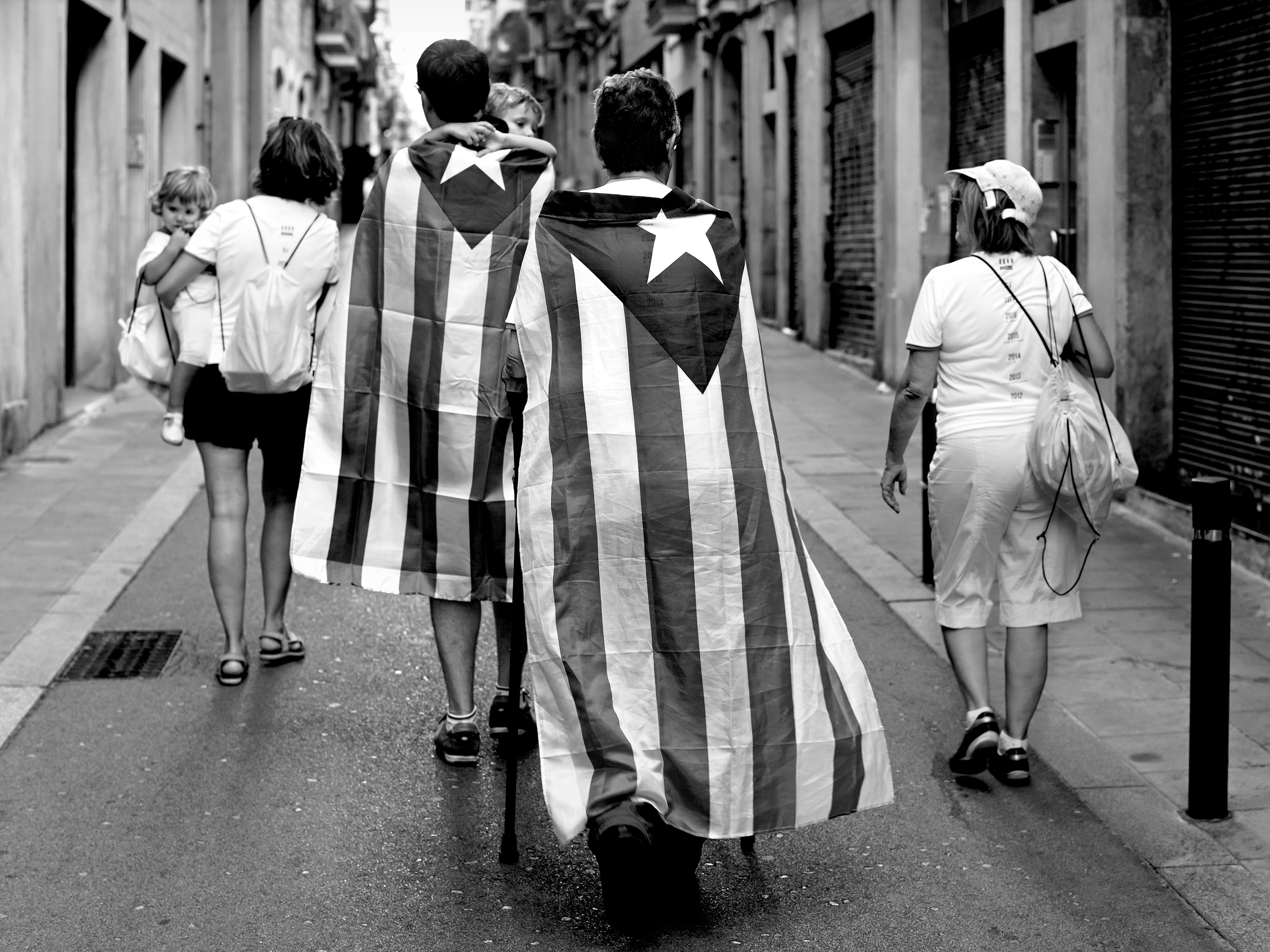 Family of Catalan independence supporters returning from a protest marchBarcelona, Spain, 2017photography, bw, single