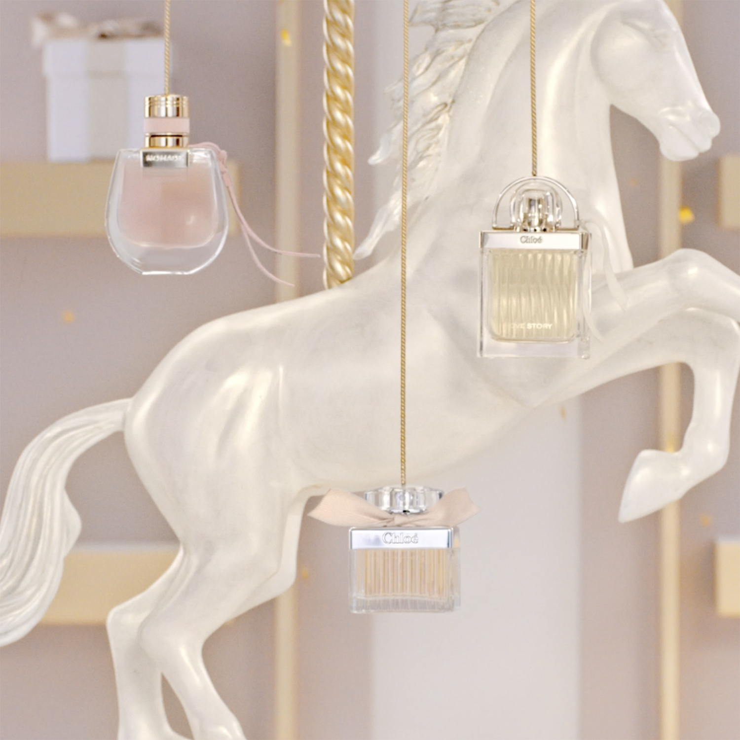 KMA photographer Vincent Gapaillard photographs a Chloe rose gold perfume bottles in front of a pink Chloe store window