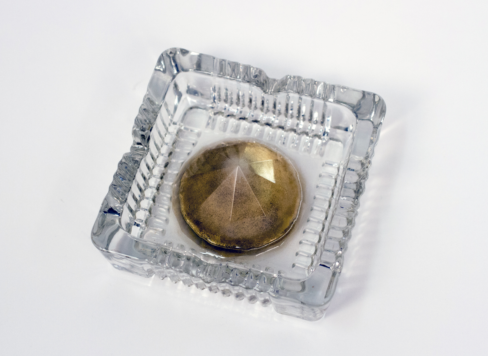 Staś, 2019, 4"x4"x1.25". Glass, brass powder, epoxy resin