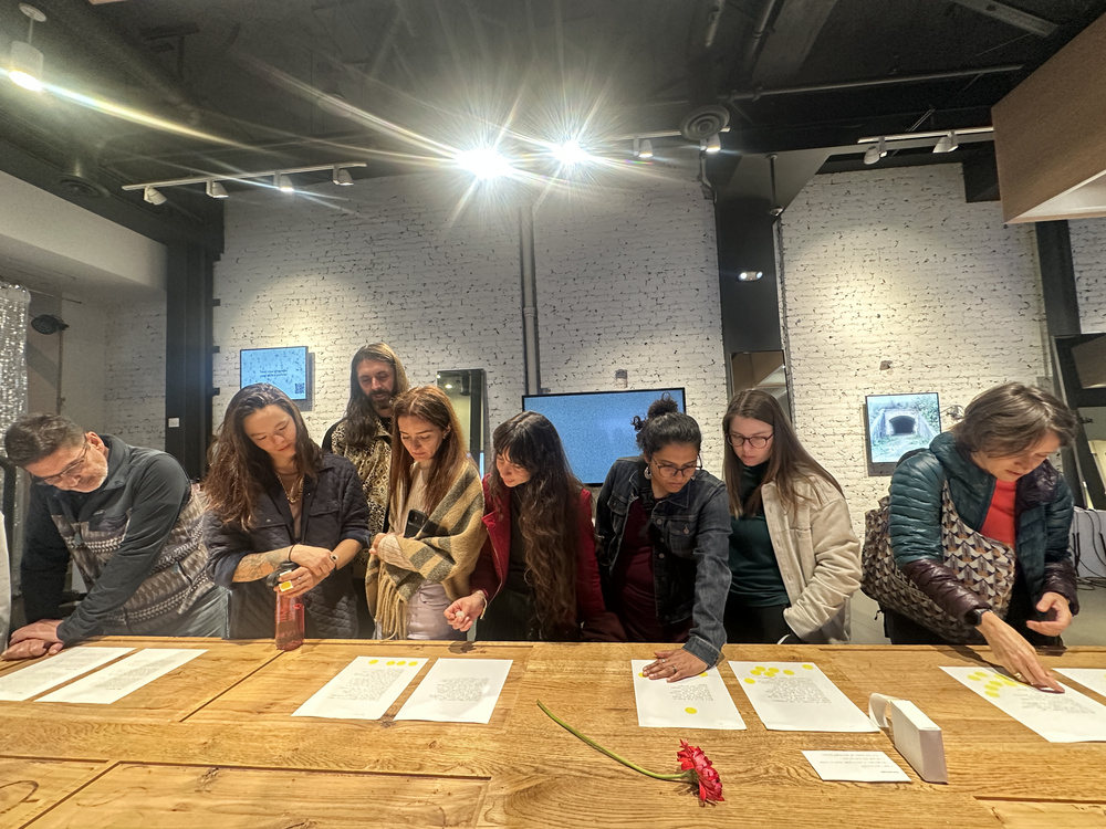 Audience engaging with printed poems