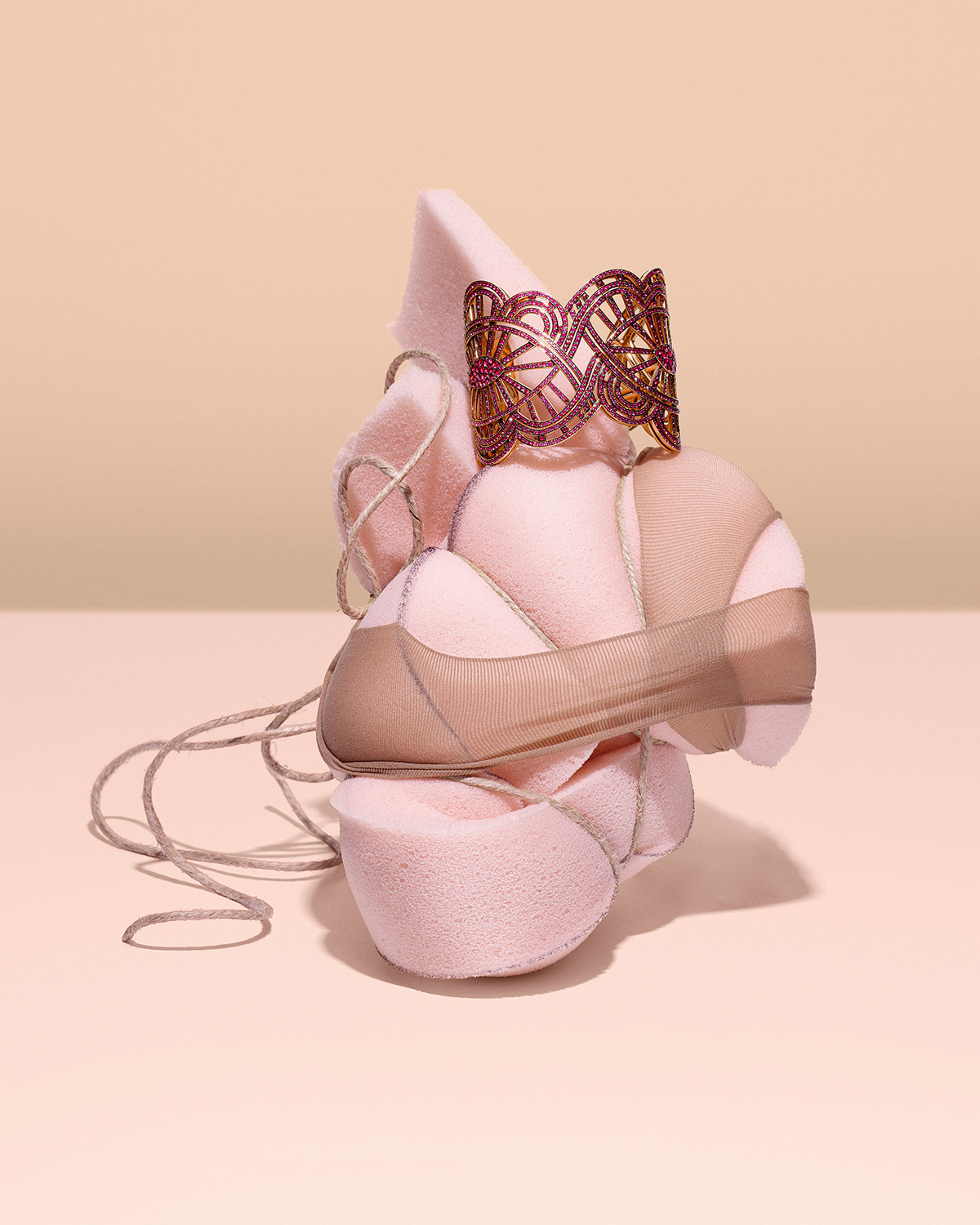 KMA photographer Isabelle Bonjean shoots photograph of pink bracelets against a nude pink background 