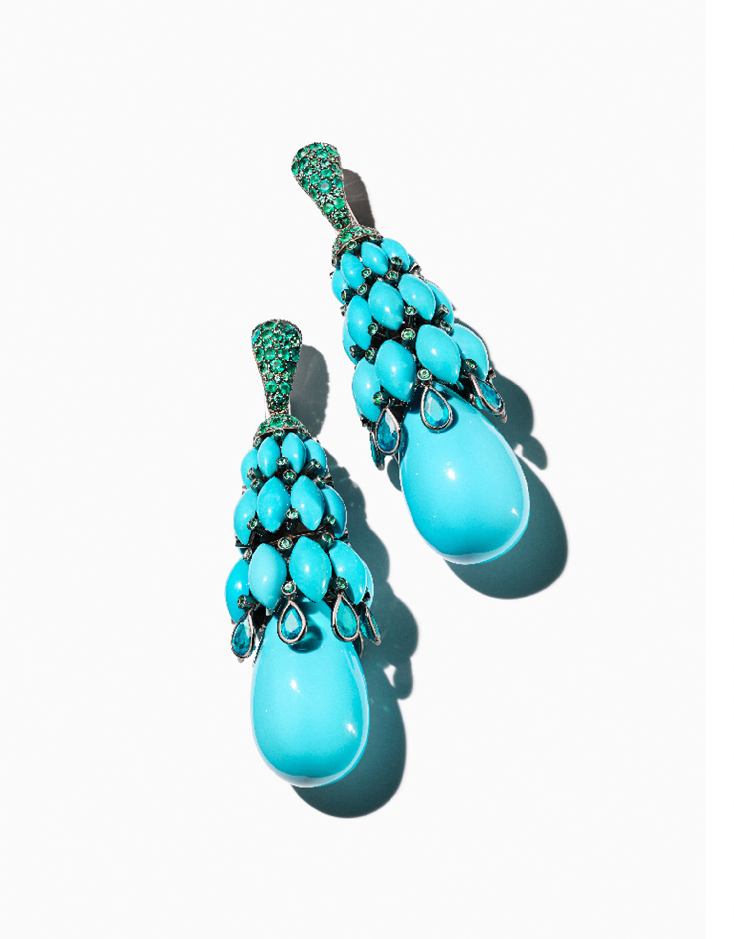 KMA stylist Sara Wacksman designs set for a photo of blue raindrop earrings against a white background for Bergdorf Goodman