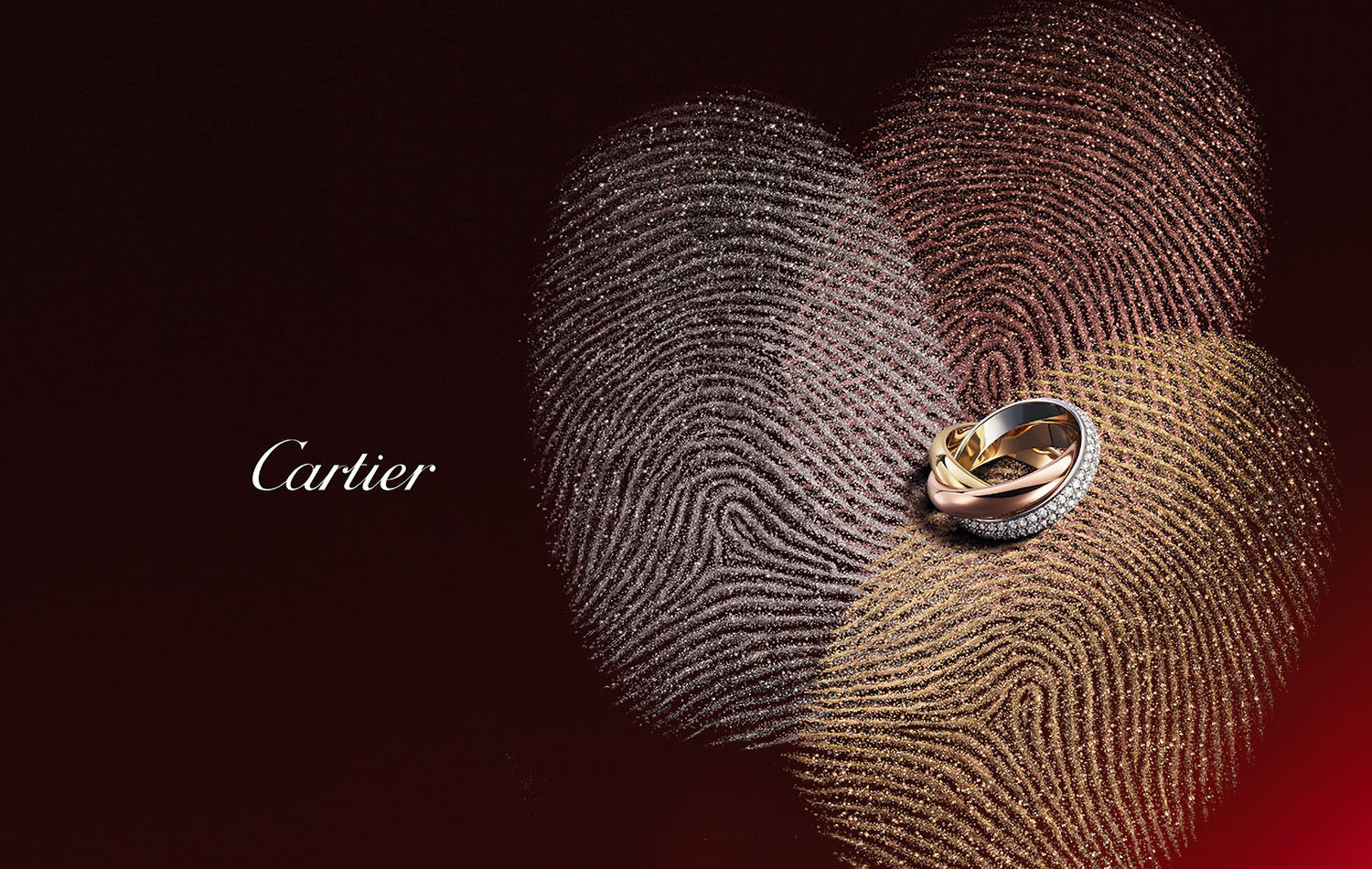KMA photographer Daniel Schweizer photographs a ring on a red surface with multicolored sparkling finger prints for Cartier