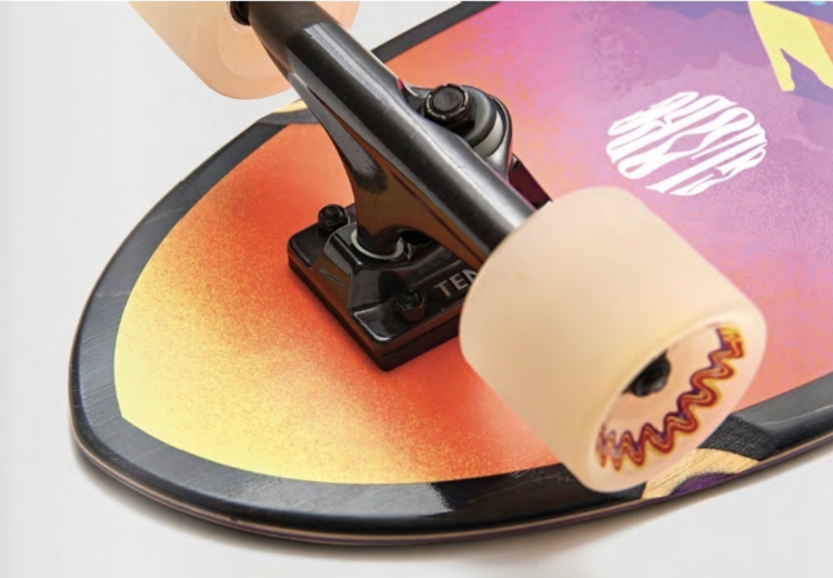 sunset colored close up of wheel on sunset colored skateboard deck 