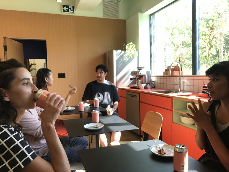 Photo of WORKSHOP team members eating cake in the studio kitchen