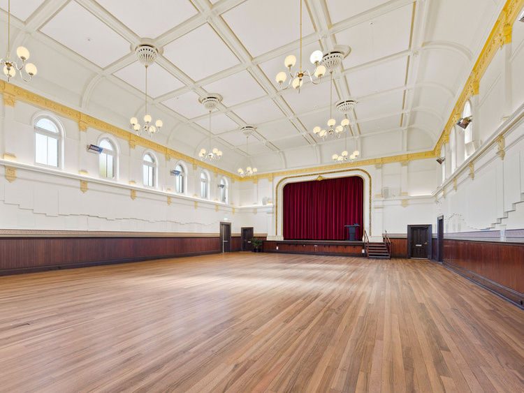 Interior Kensington Town Hall. Spacious, bright, wood floorboards and hanging lights.